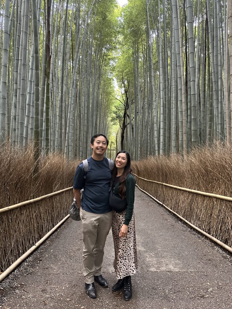 Walking through the serene Arashiyama Bamboo Forest in Kyoto, Japan, with tall green bamboo stalks towering overhead
