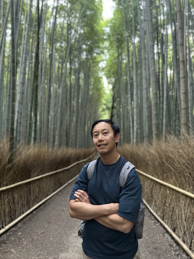 Lush green bamboo stalks creating a tranquil canopy at Arashiyama, Kyoto’s iconic bamboo grove