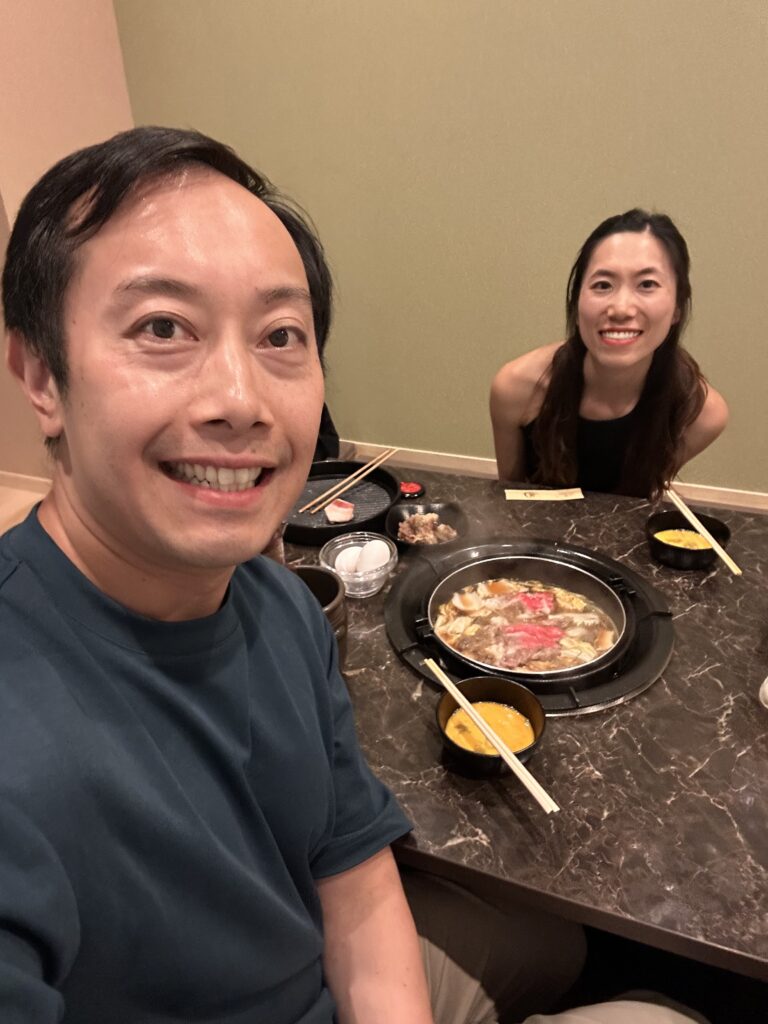 Enjoying a Japanese sukiyaki buffet with unlimited thinly sliced beef and fresh vegetables at a restaurant in Kyoto