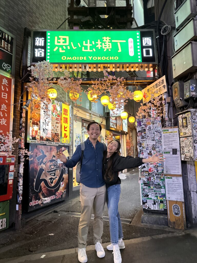 Couple exploring Omoide Yokocho and enjoying yakitori in Shinjuku Tokyo experiences