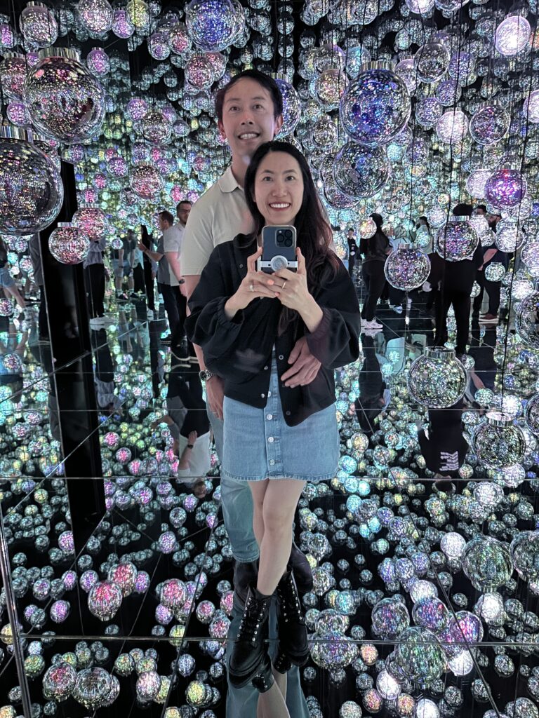 Couple enjoying interactive light installations at TeamLab Borderless museum