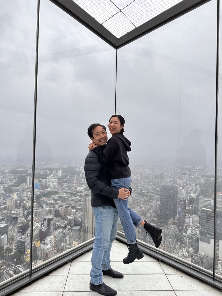 Couple posing at Shibuya Sky observation deck in Tokyo Japan