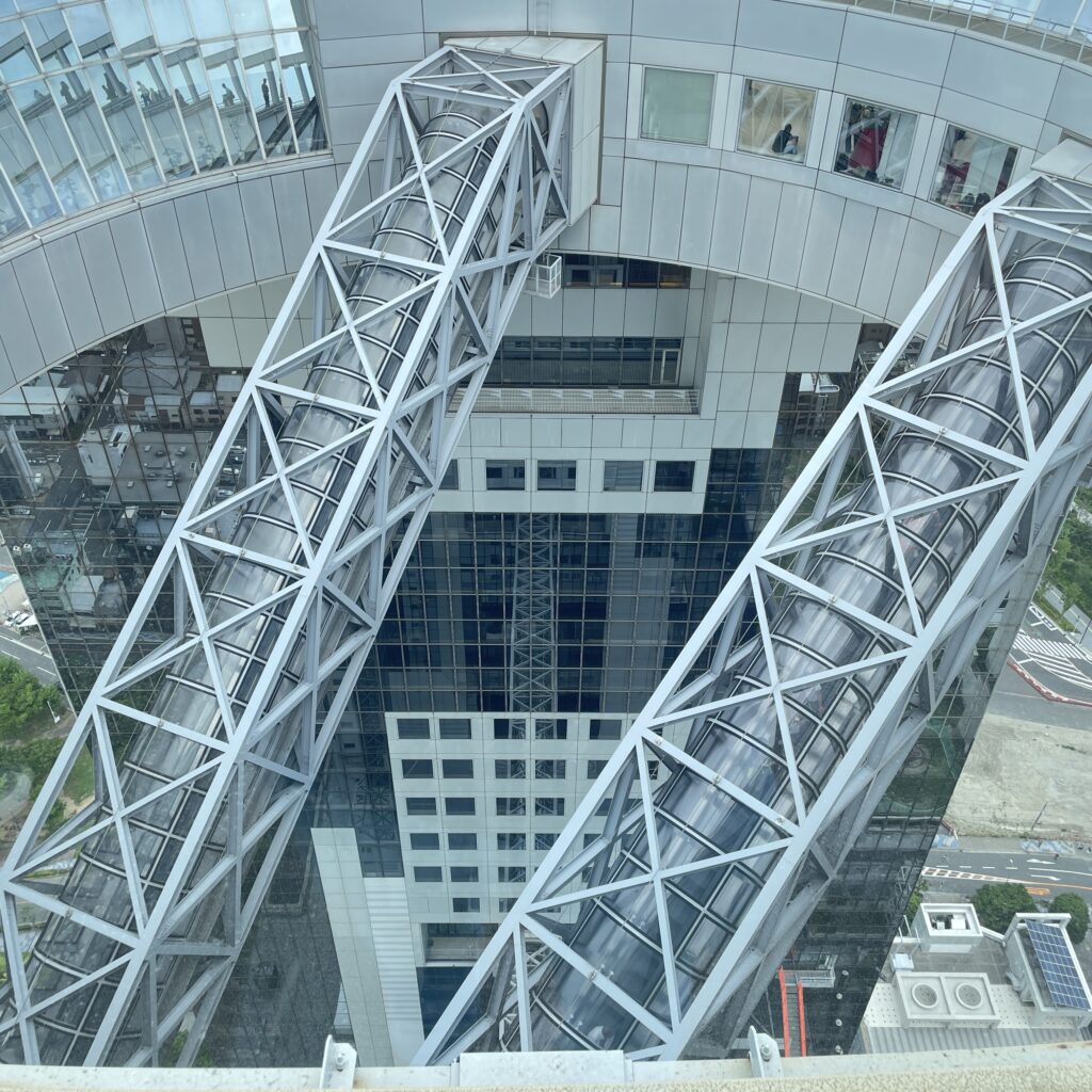 Umeda Sky Building in Osaka, featuring open-air escalators leading to a floating garden observatory.