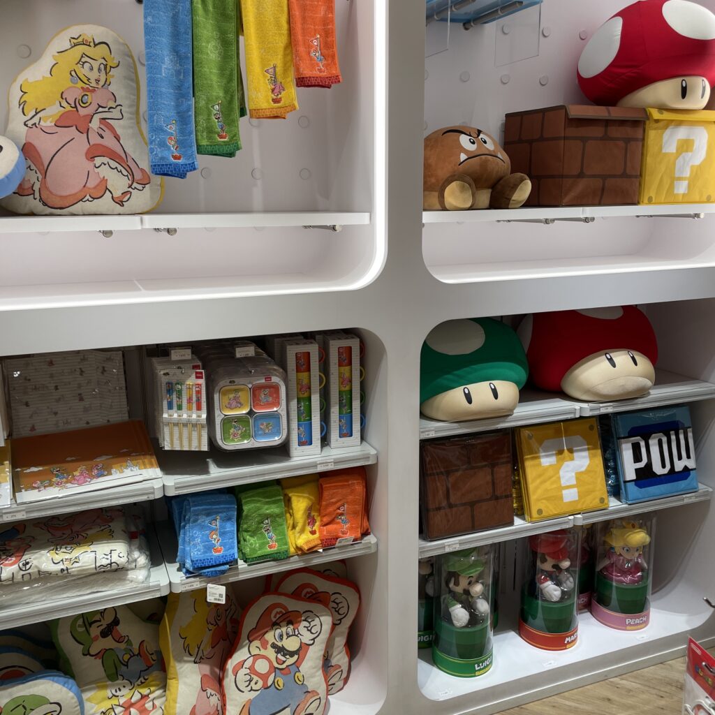 Osaka’s Nintendo Store featuring a bright red sign, character displays, and shelves filled with game merchandise.