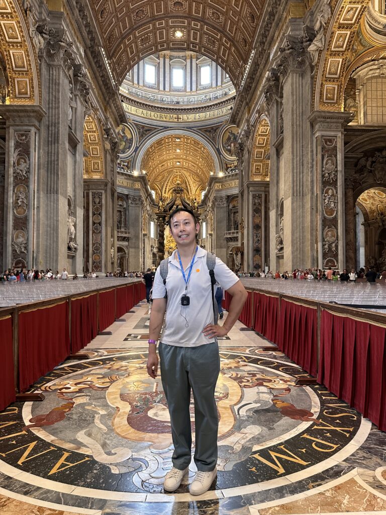 Interior of St. Peter’s Basilica with ornate marble columns and gilded details.