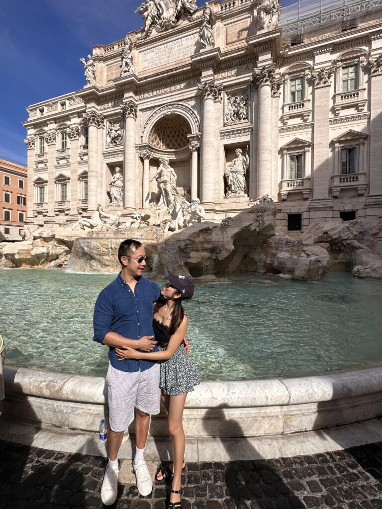 Trevi Fountain cascading water over ornate statues in Piazza di Trevi, Rome.