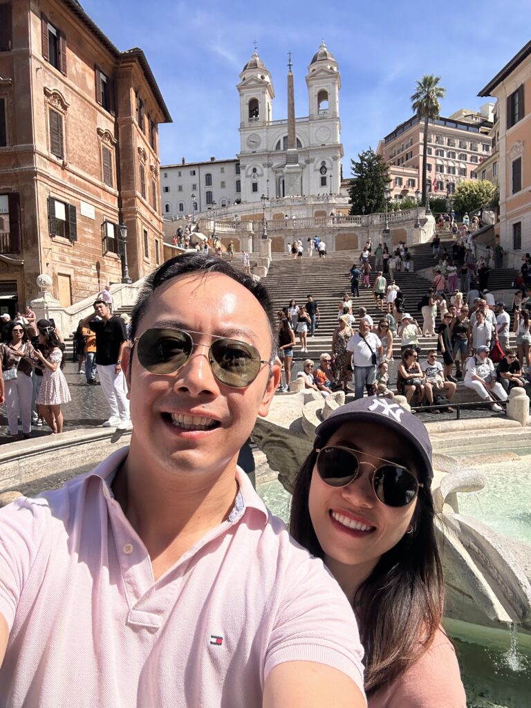 Sunlight illuminating the Spanish Steps with visitors enjoying the scene.